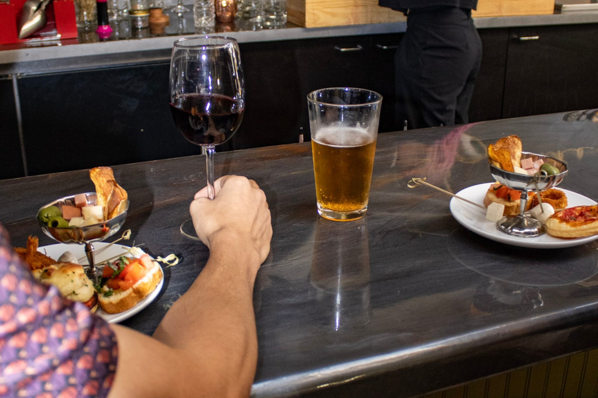 Untitled design Guest selecting complimentary aperitivo bite at Slowly in Pacific Beach, San Diego